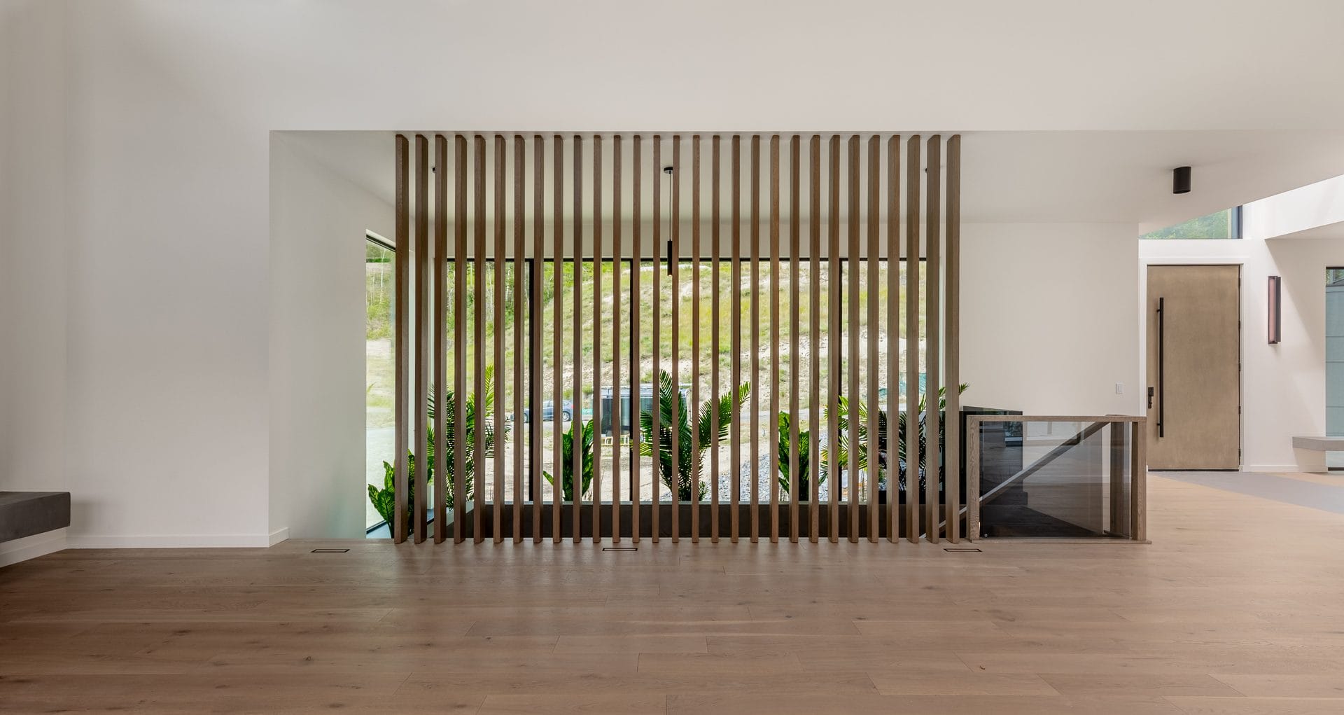 Vertical wood slat screen wall, a custom millwork detail in a West Ridge home