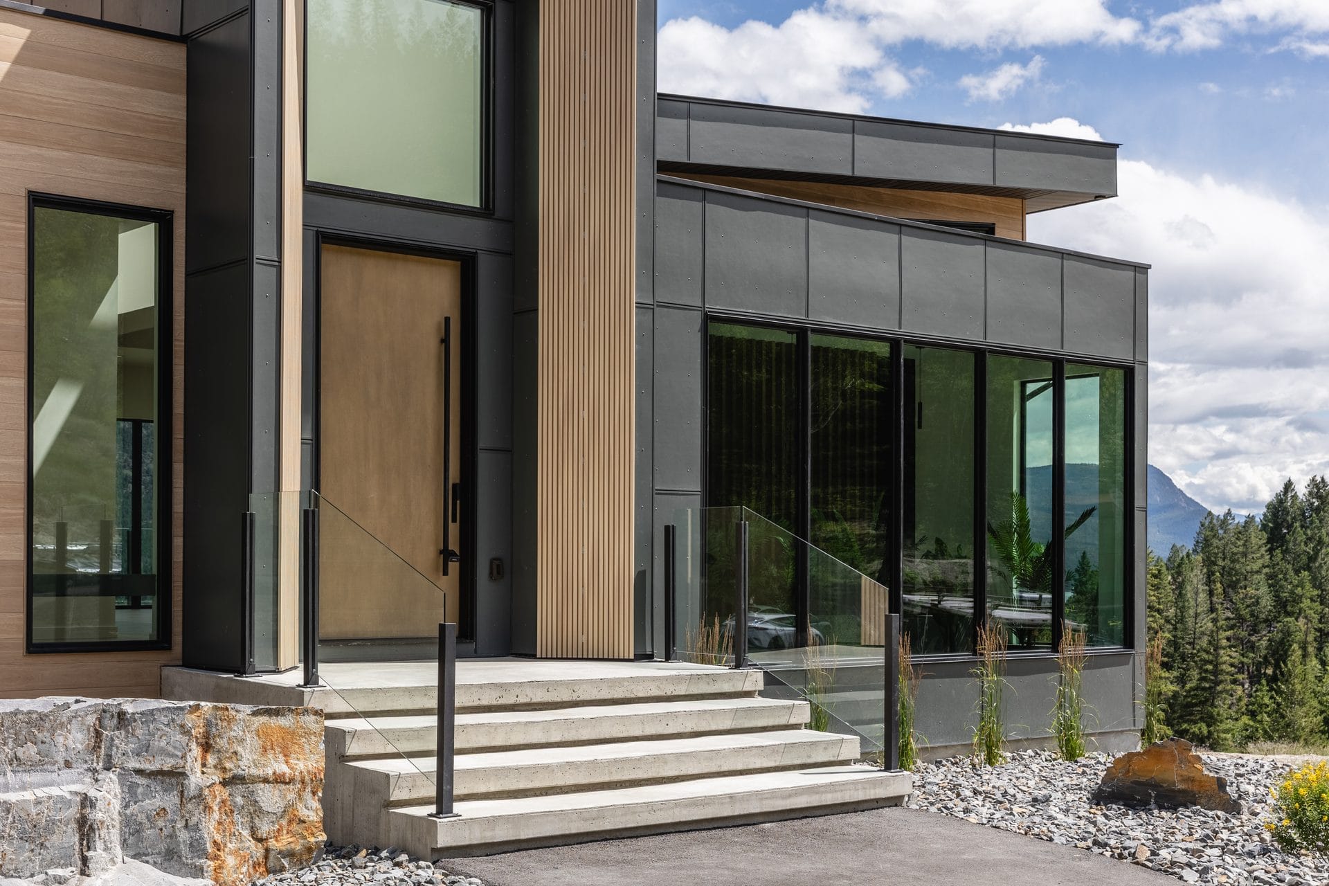 Concrete entry steps and wood-clad recess at Springwater Hill